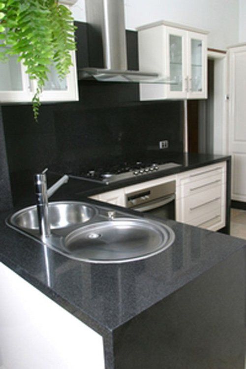 modern kitchen with black granite countertops