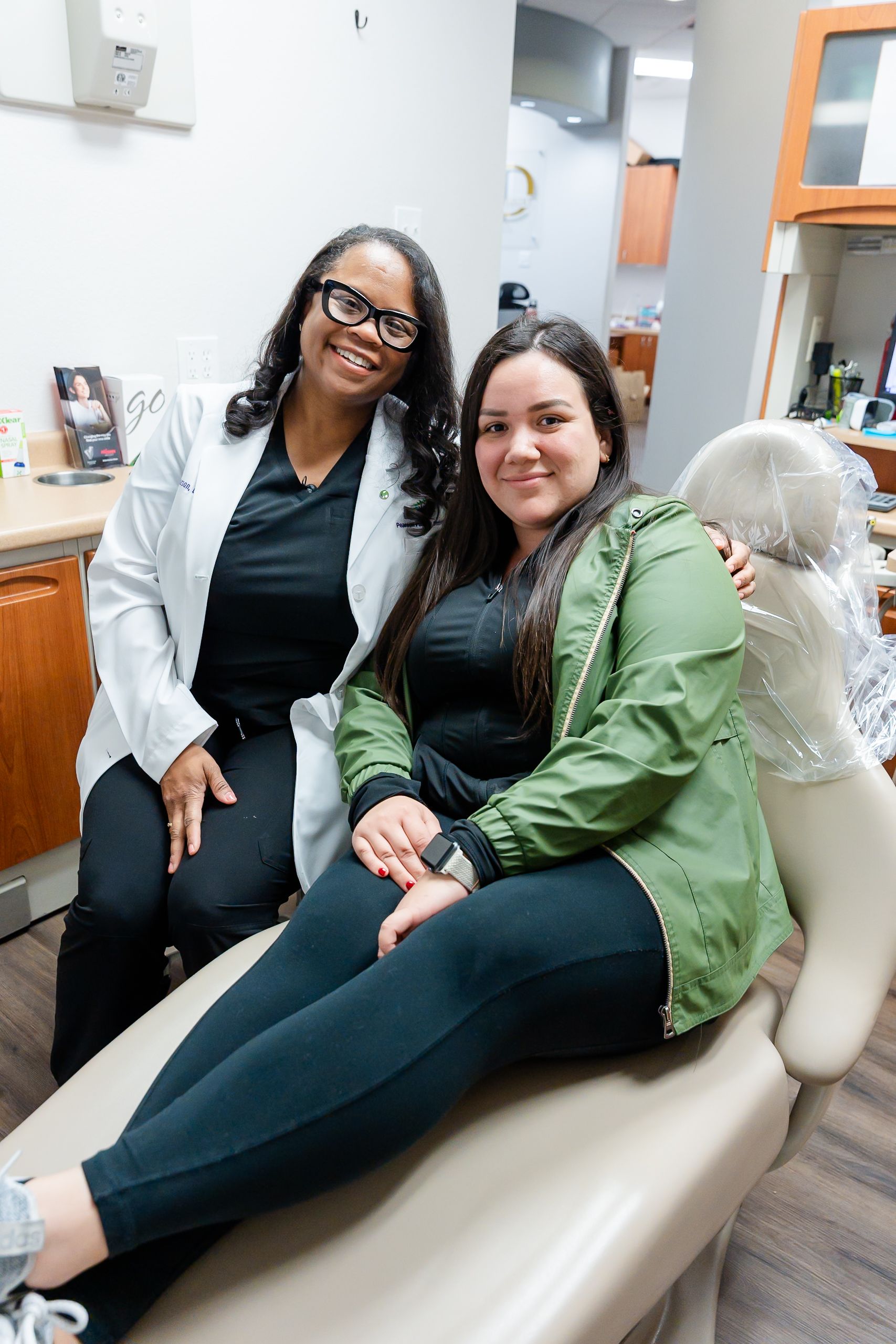 A man is holding a tooth color chart in front of his mouth.