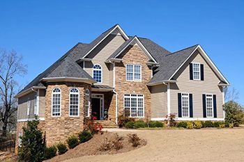 A large house with a blue sky in the background