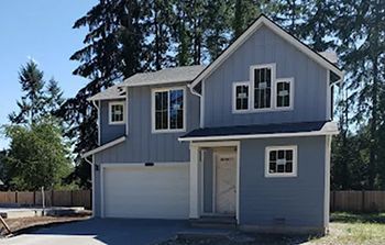 A house with a garage and a lot of windows