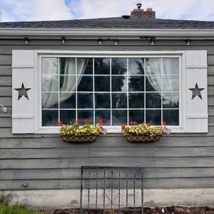 A house with a large window and shutters on it.