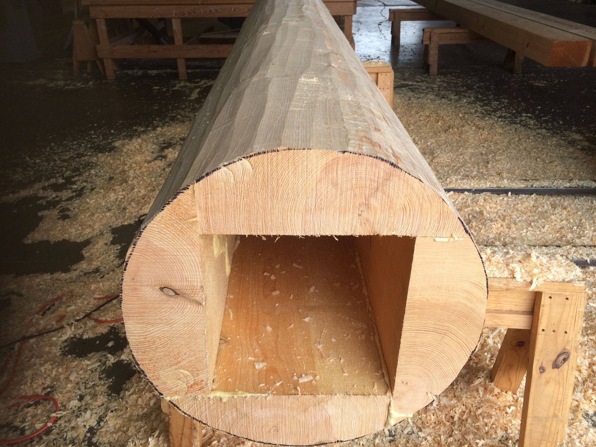 a false log carved to enclose a steel beam