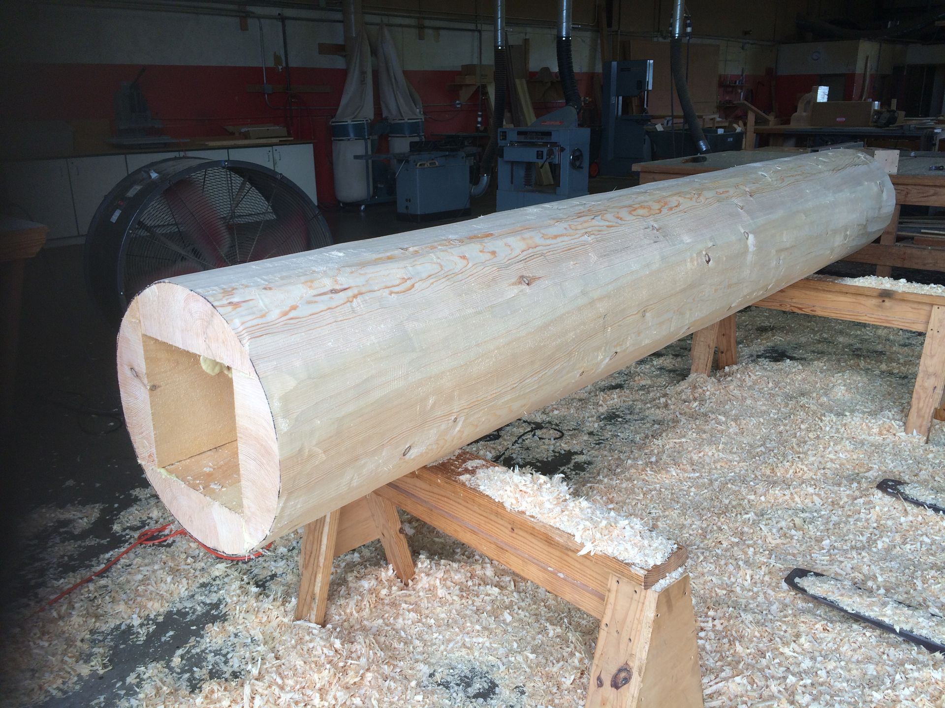 a log hollowed out to fit around a steel post