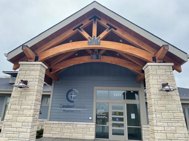 a timber truss above the entry to a building