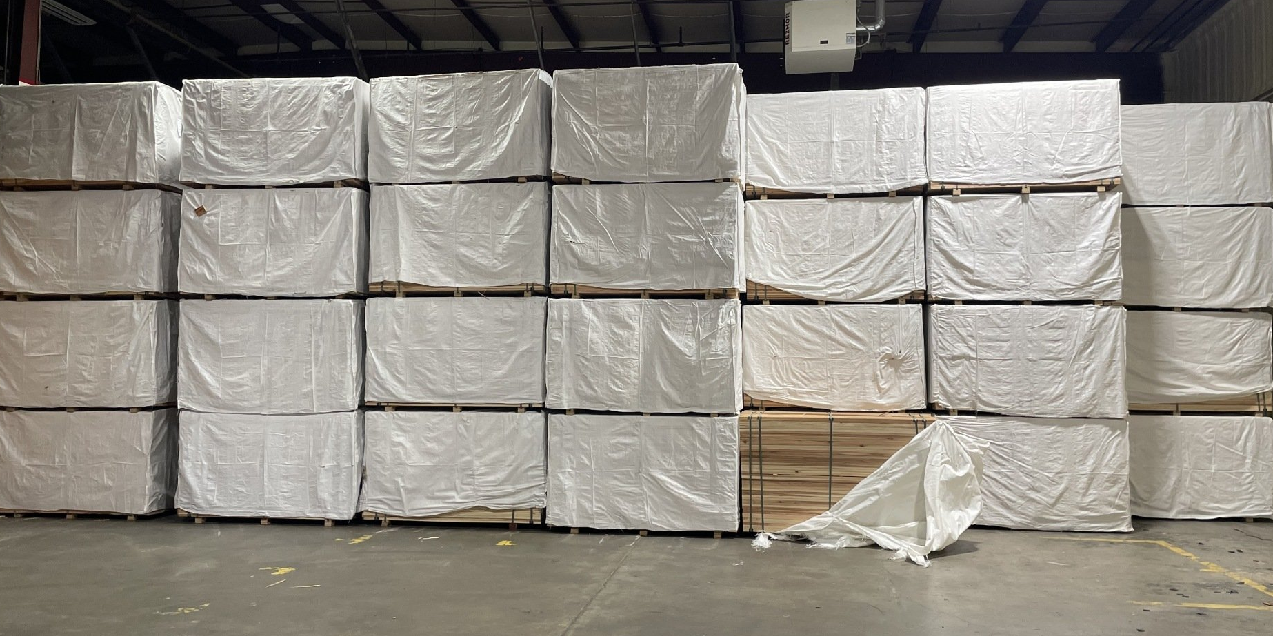 lots of wrapped stacks of wood fencing