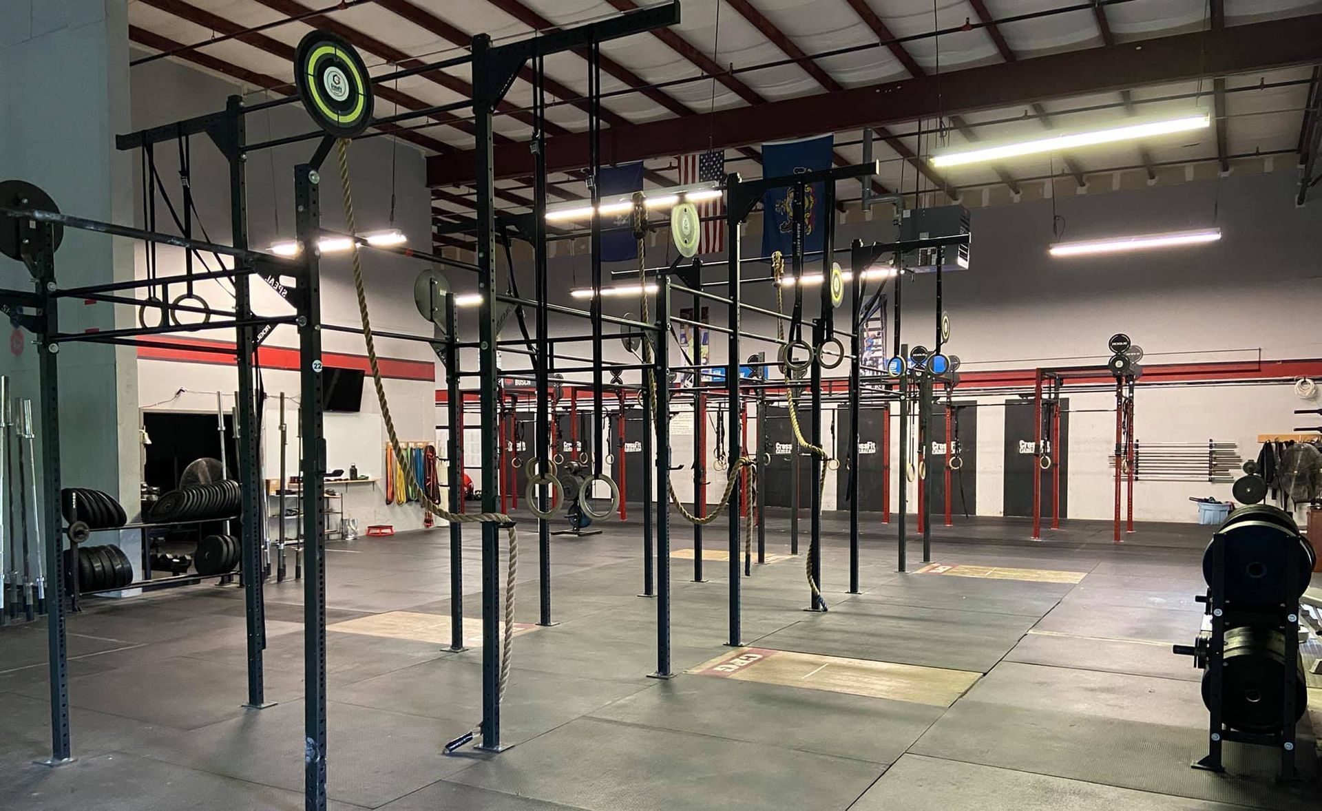 A large empty gym with a lot of exercise equipment.