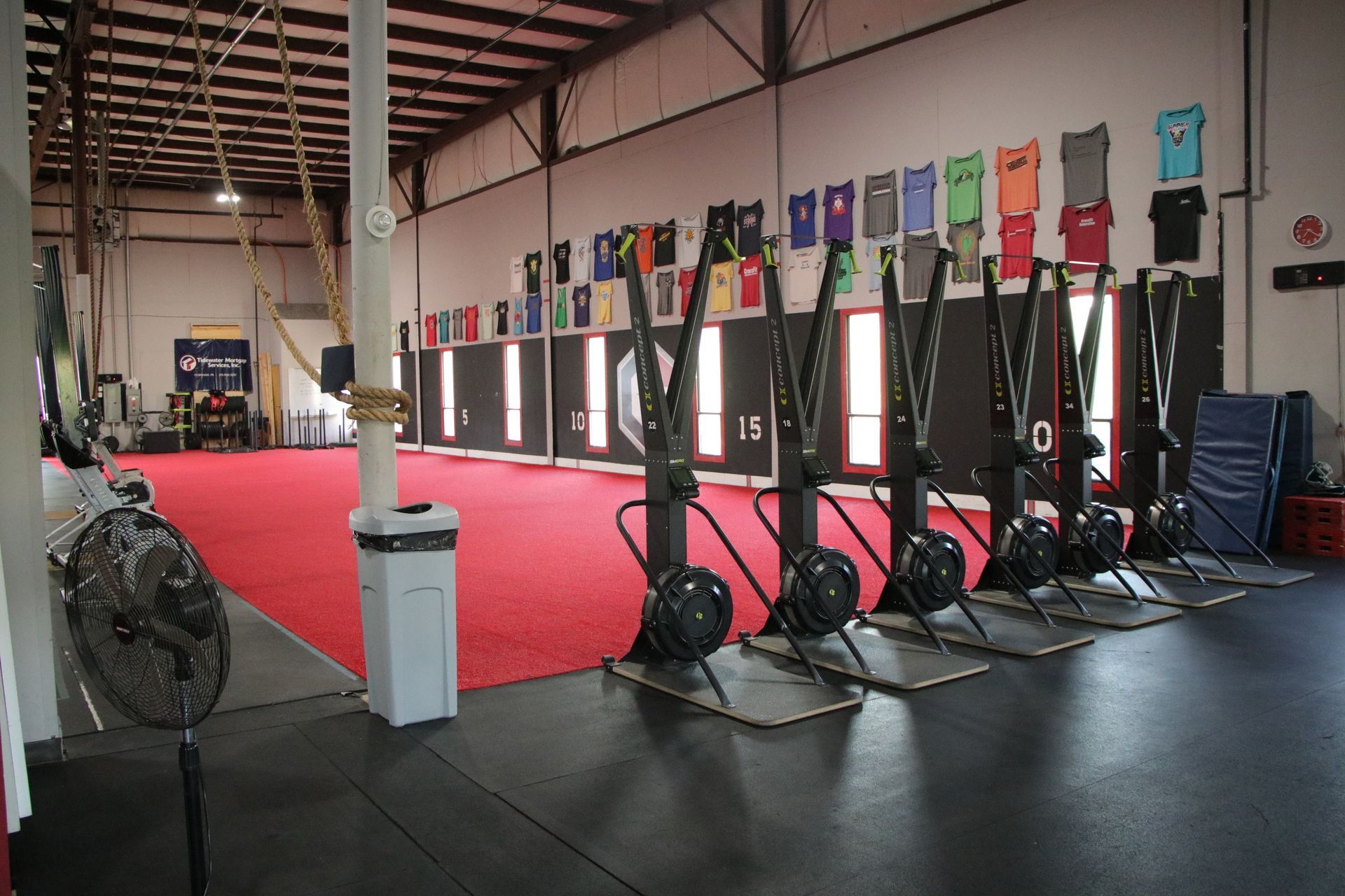 A group of people are doing squats in a gym.