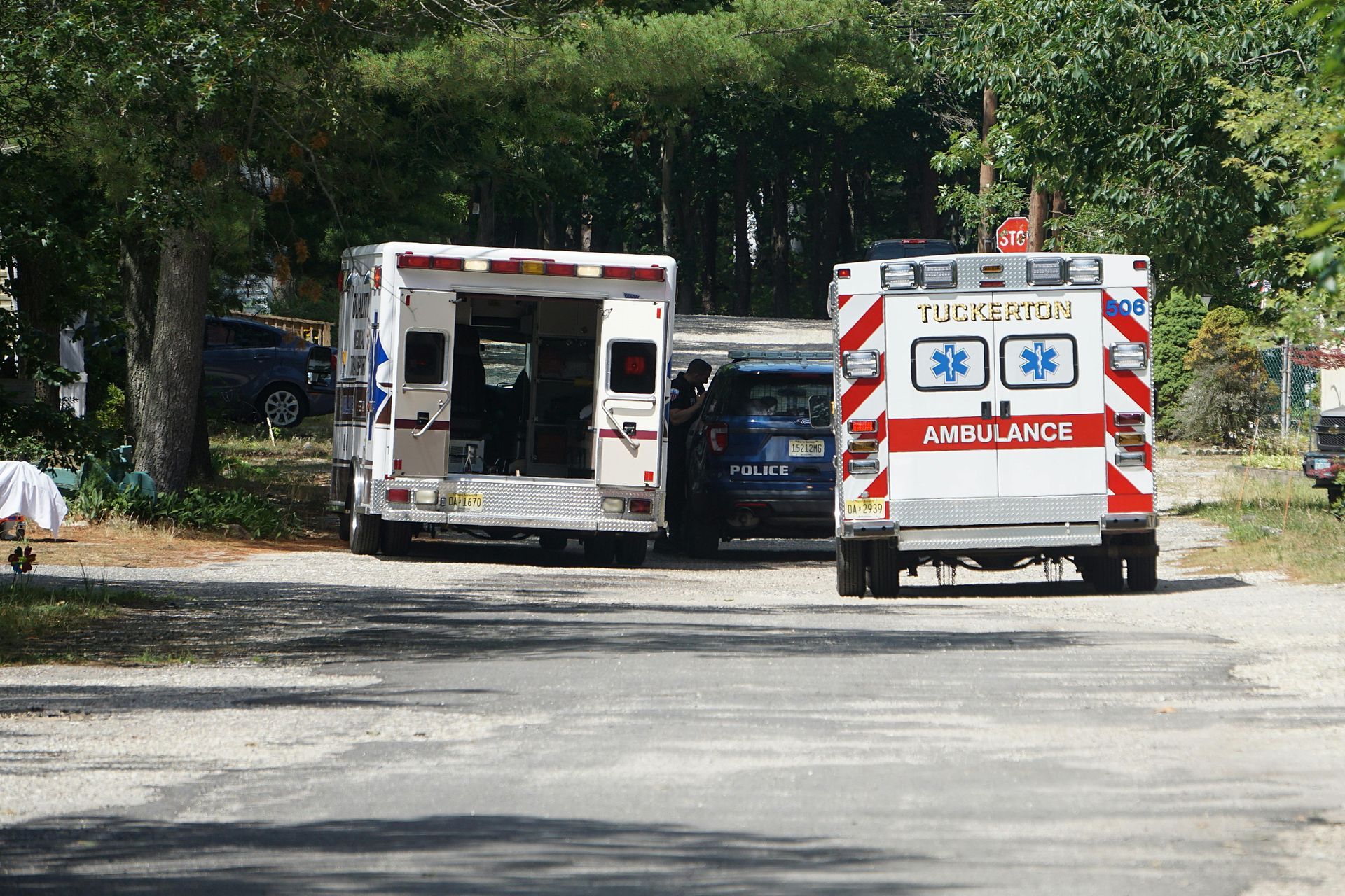 Two ambulances are parked on the side of the road.