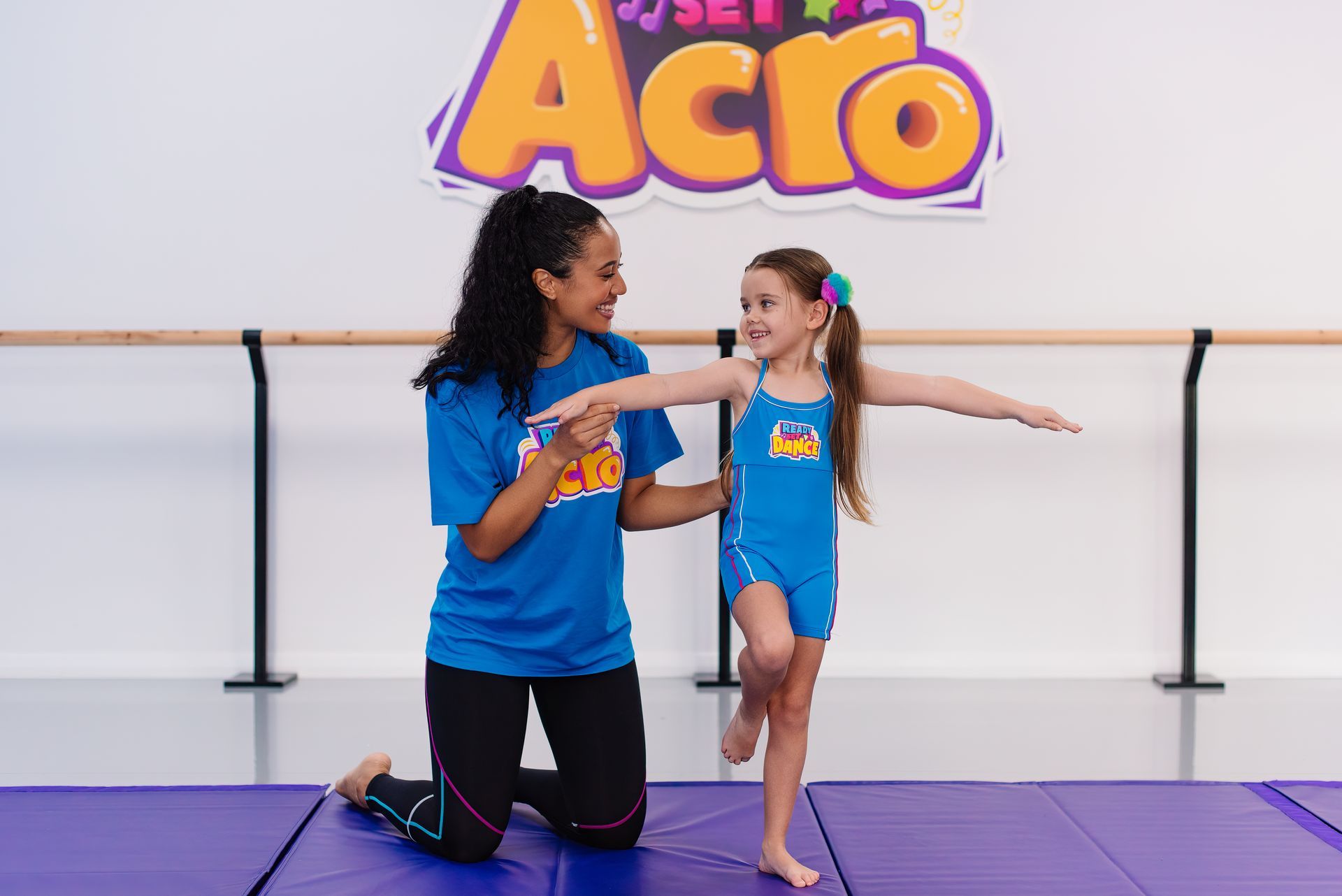 A Group Of Young People Are Posing For A Picture In A Room With Purple Lights — Dance Express Mackay In North Mackay, QLD