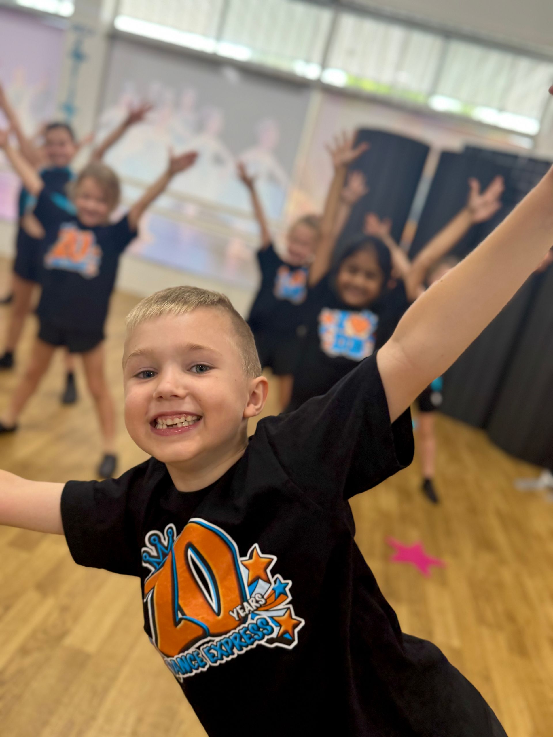 Two Little Girls Are Hugging Each Other On A Rainbow Rug — Dance Express Mackay In North Mackay, QLD