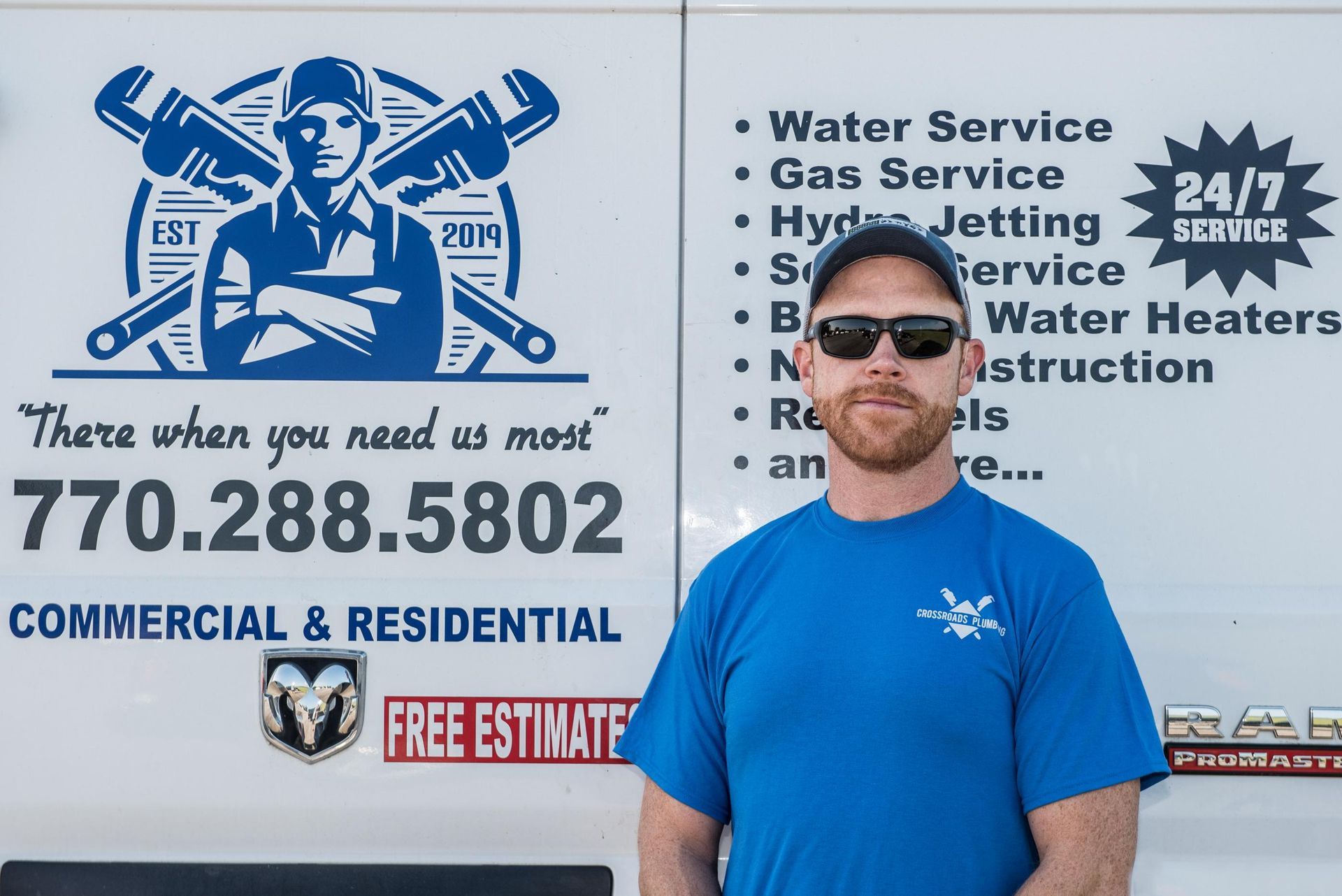 A man standing in front of a sign that says there when you need us most