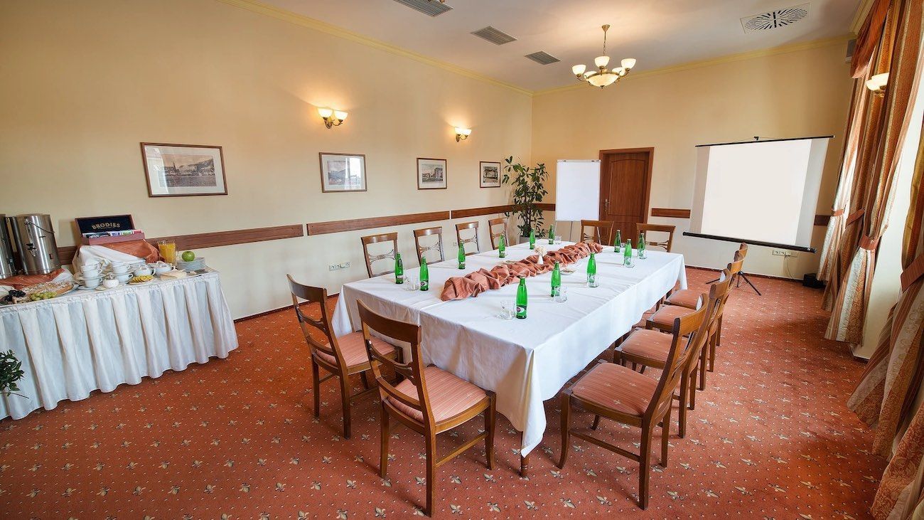 A large room with a long table and chairs.