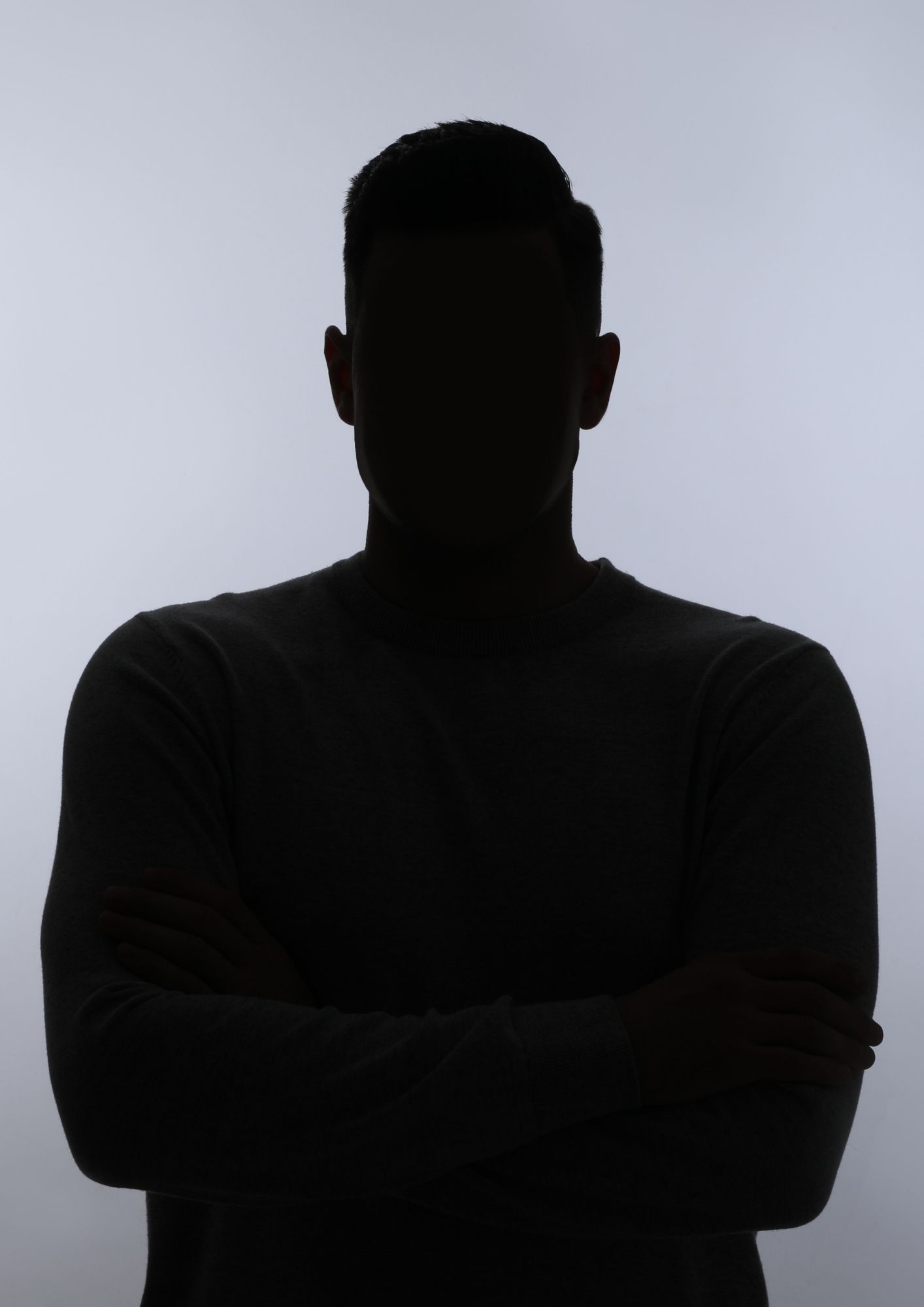 A silhouette of a man with his arms crossed