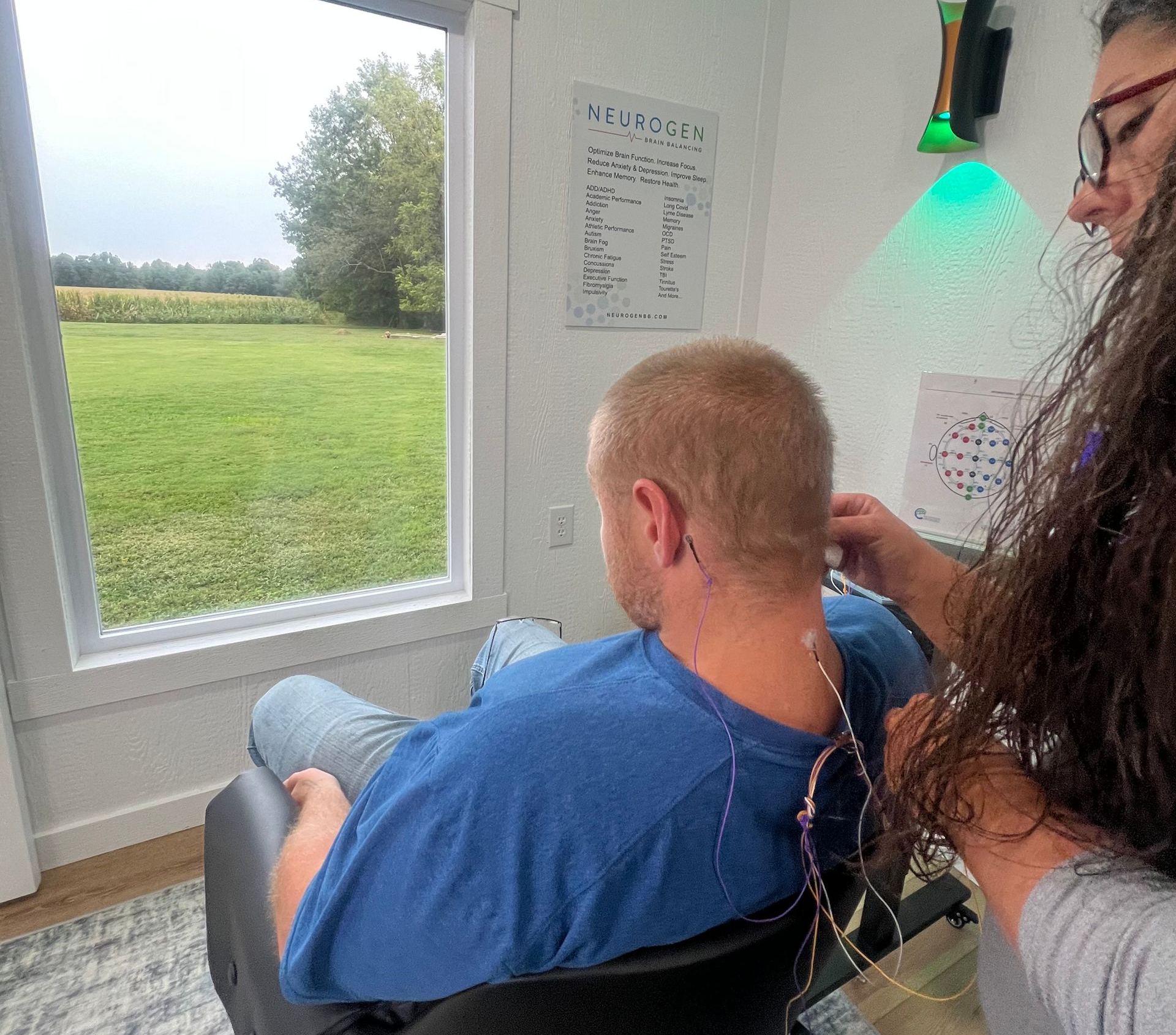 Person receiving head examination with electrodes. Hands are placing wires on the scalp.