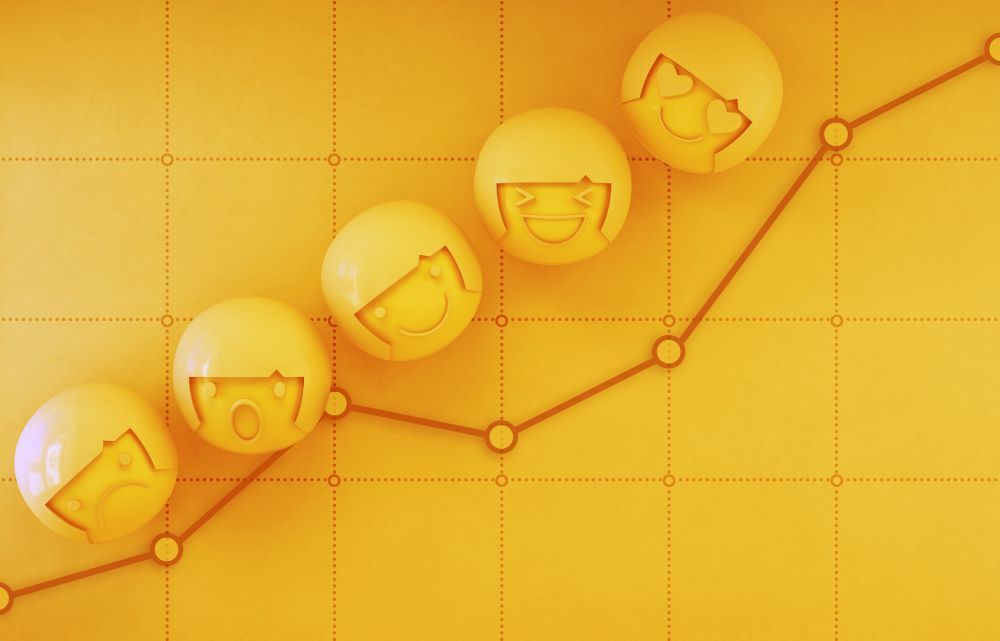 Um gráfico com carinhas sorridentes e uma linha subindo.