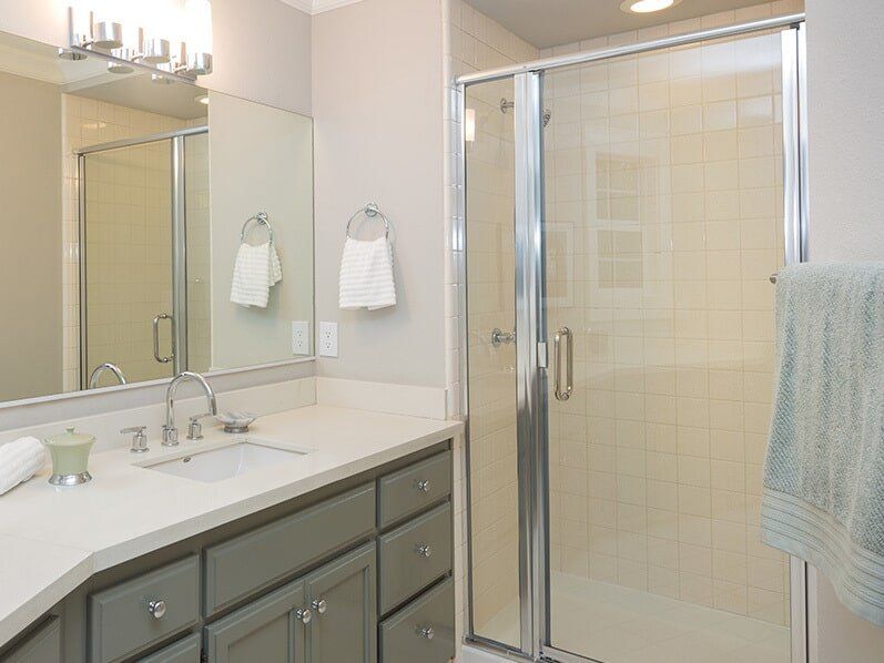 A newly installed framed shower screen in a bathroom