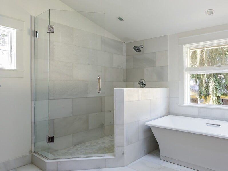 A frameless shower screen installed in a new bathroom in Cairns