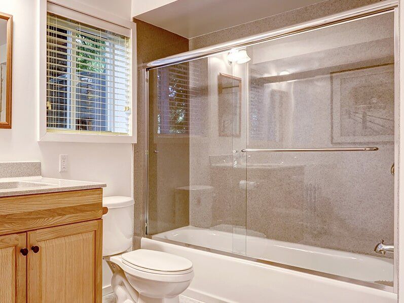 A glass bath tub screen installed in a bathroom in Cairns