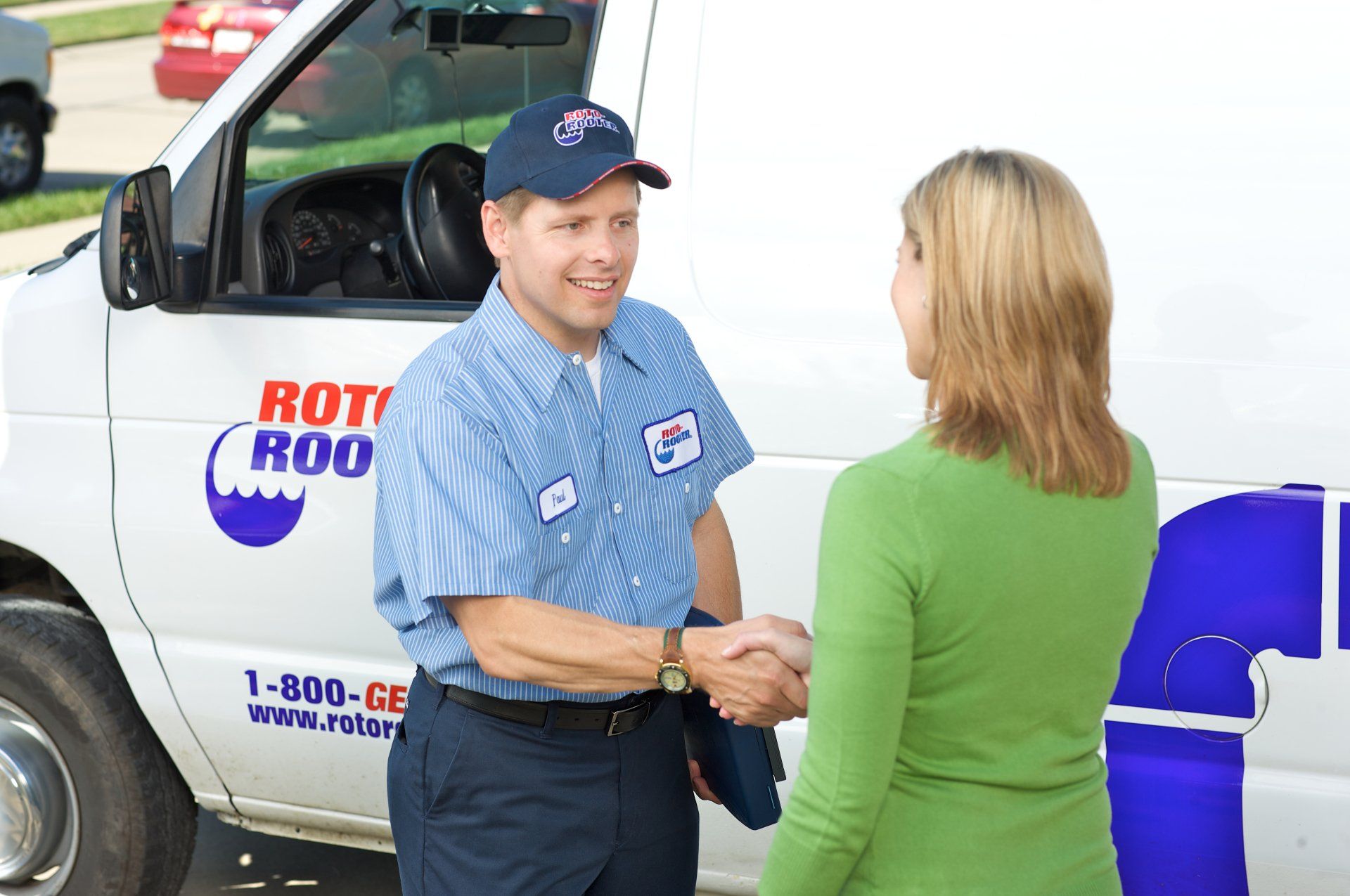 An experienced plumber meeting with a client in Battle Creek, MI