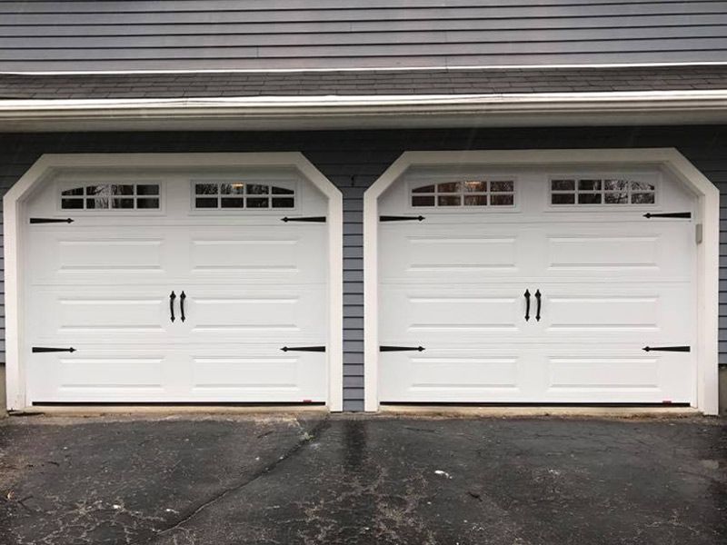 A pair of white garage doors sitting next to each other
