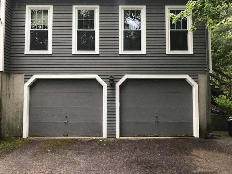 A house with two garage doors and three windows