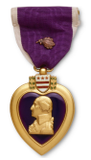Purple Heart medal with bust of George Washington, purple ribbon, and gold trim.