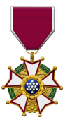 Medal with a maroon and white ribbon; gold, green, and blue star-shaped emblem.