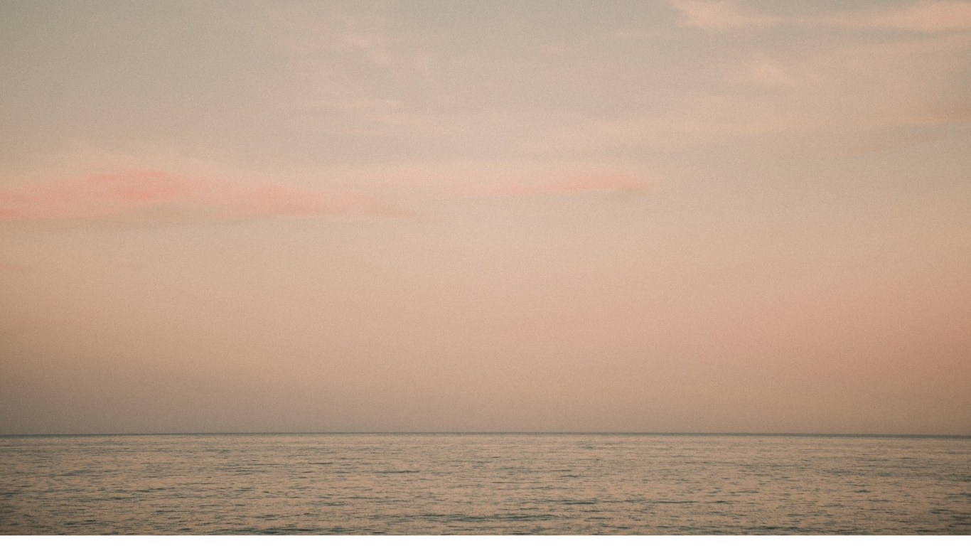 a soothing background of a pink ocean and clouds landscape