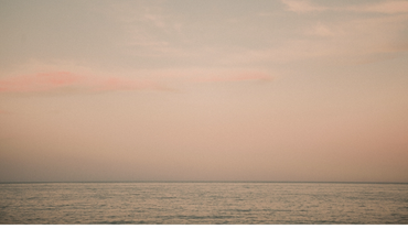a soothing background of a pink ocean and clouds landscape