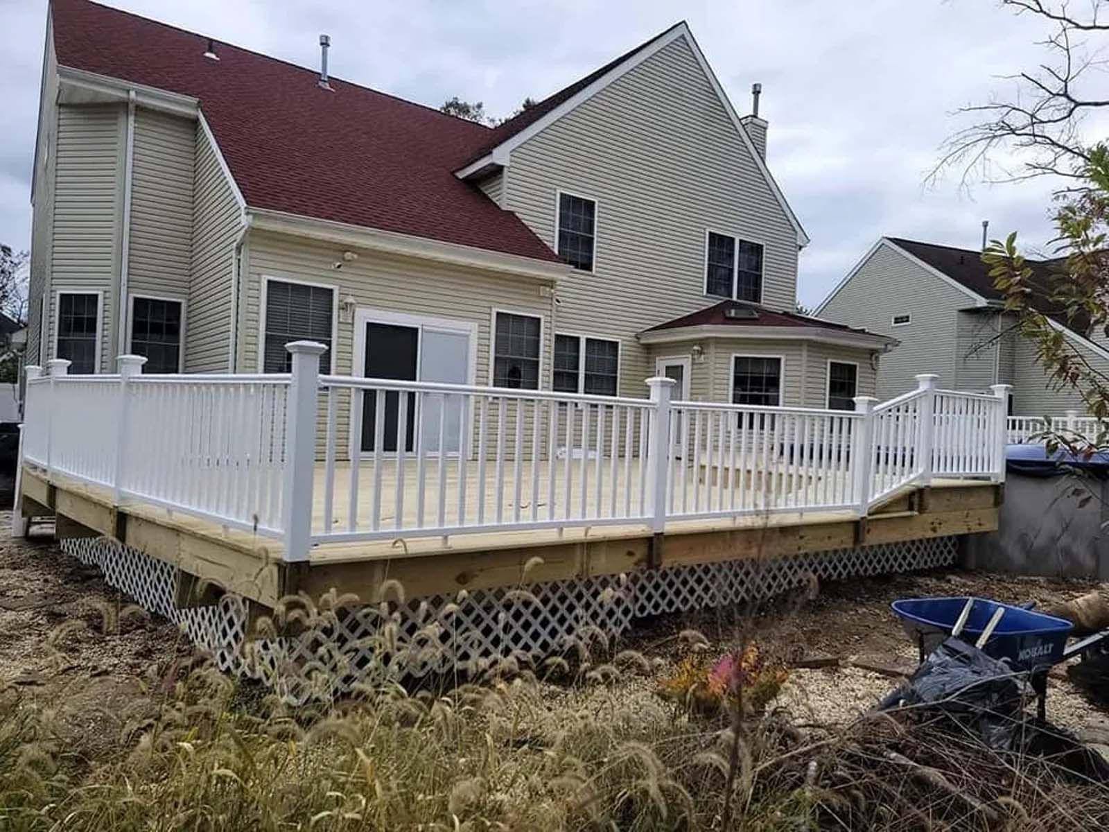 A large house with a large deck in front of it.