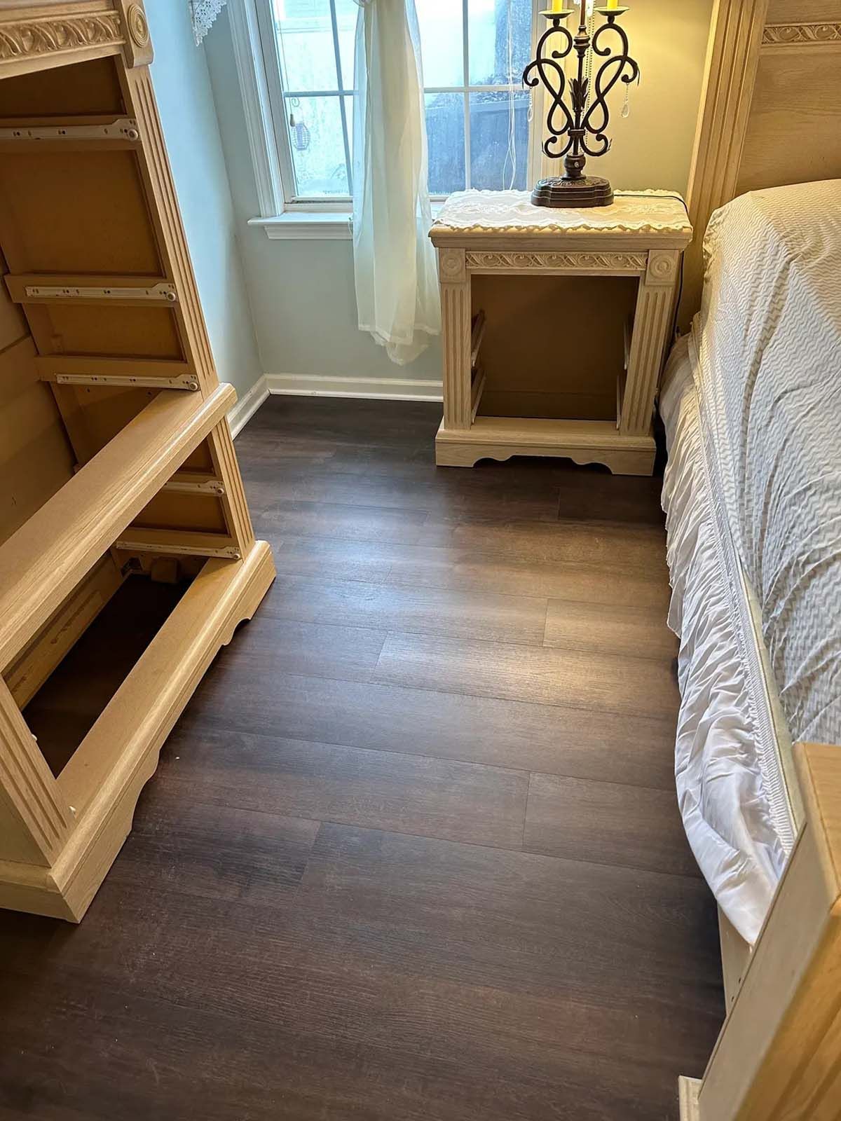 A bedroom with a bed , nightstands , and a window.