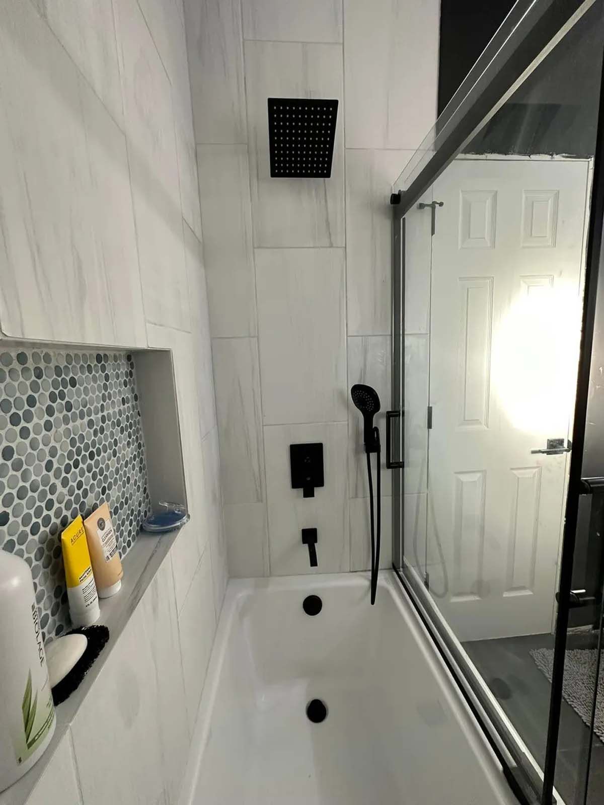 A bathroom with a bathtub and a shower stall.