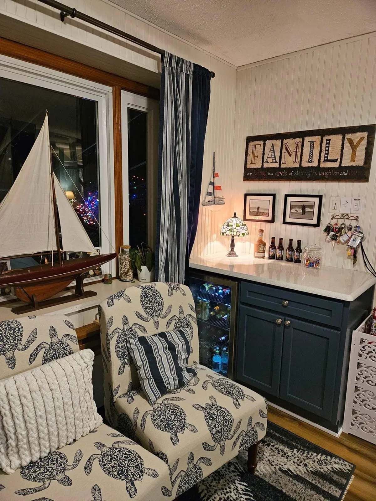 A living room with a couch , chair , and a boat model.