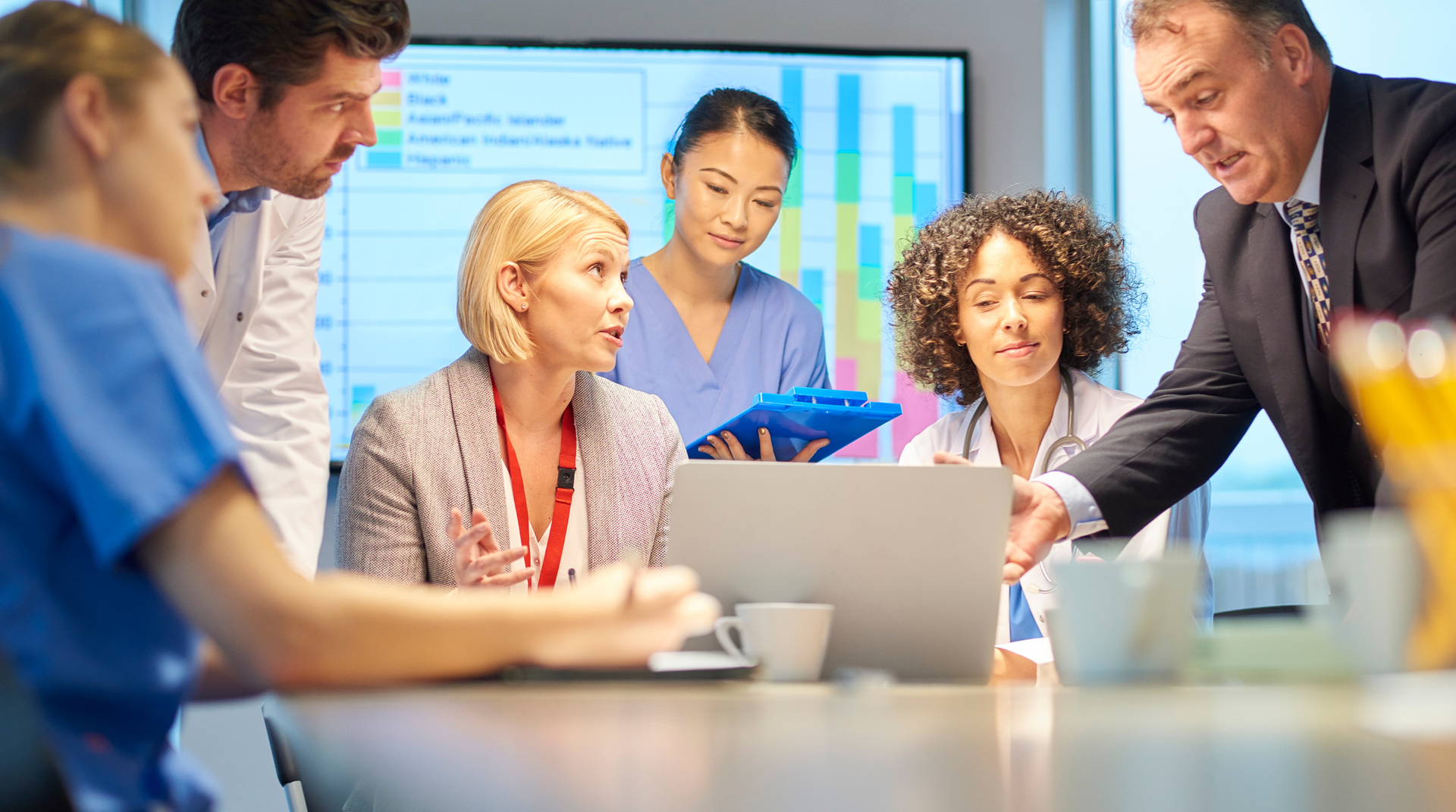 Healthcare professionals leading an onsite staff education meeting