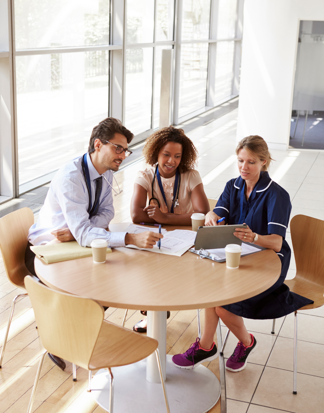 Healthcare professionals reviewing technology and operational requirements