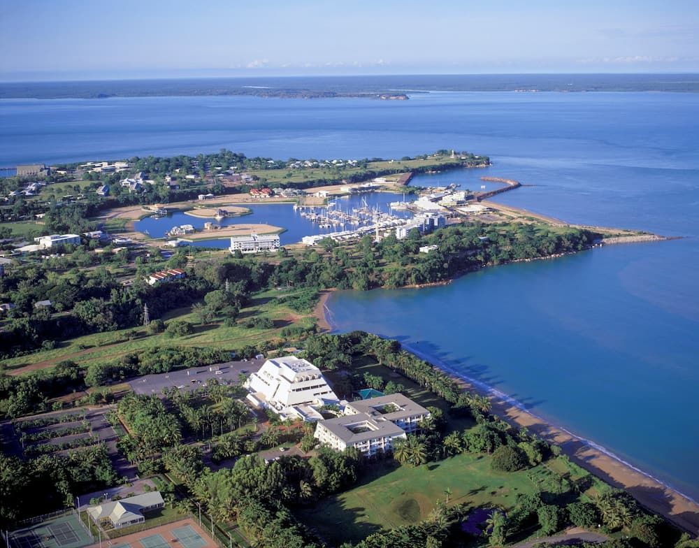 Aerial View of a Coastal Town With a Marina, Buildings, and Blue Water — Quack Pest Control in Parap, NT
