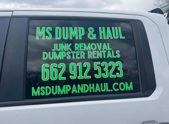 A family is posing for a picture at a christmas tree farm.