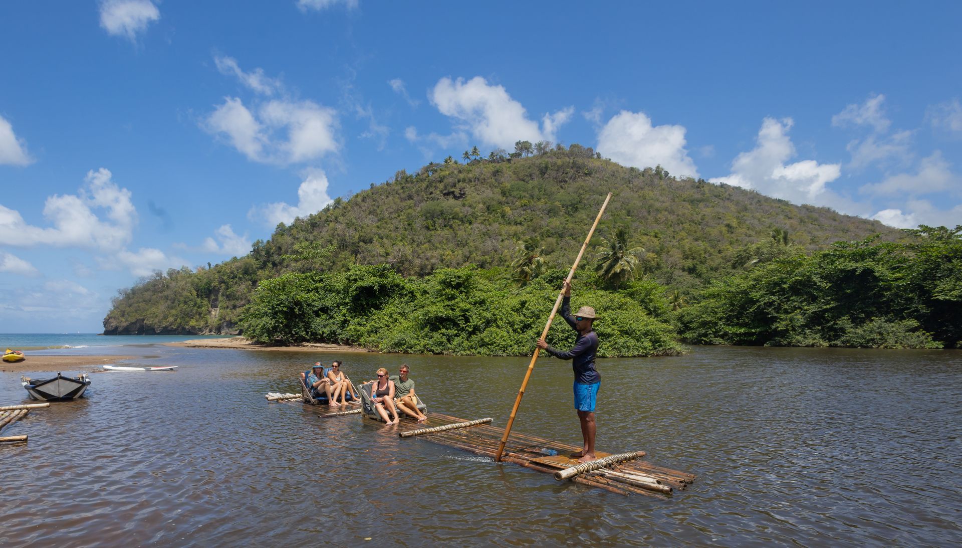 A group of people are sitting on a raft in the water.