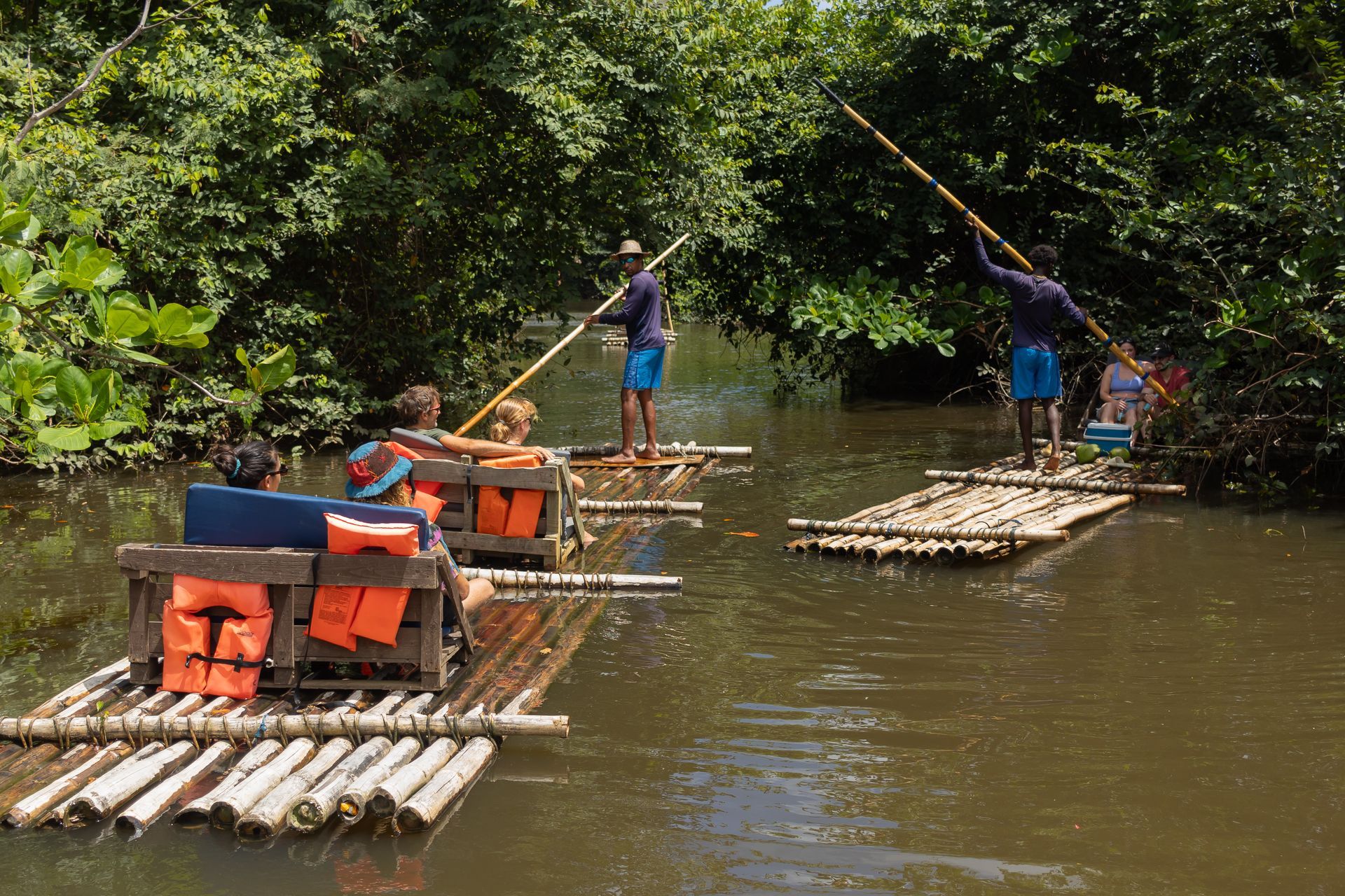 A group of people are floating on rafts in a river.