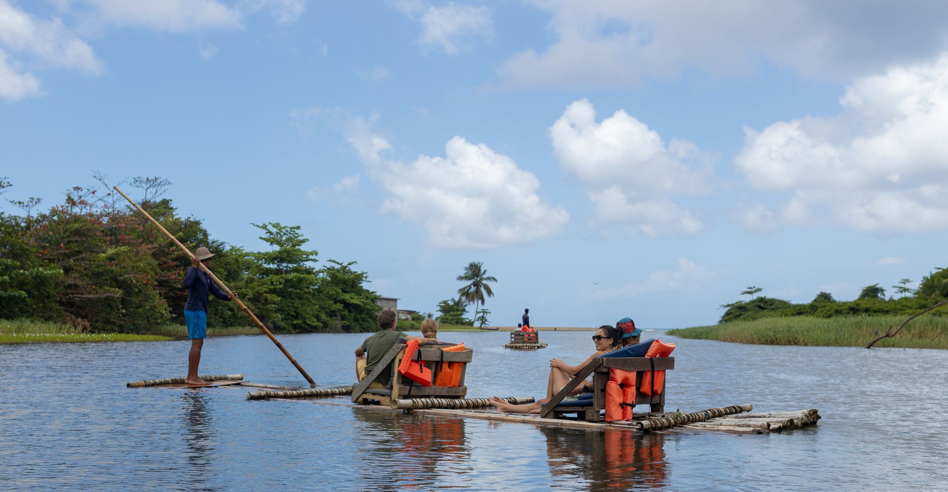 A group of people are floating on rafts in the water.