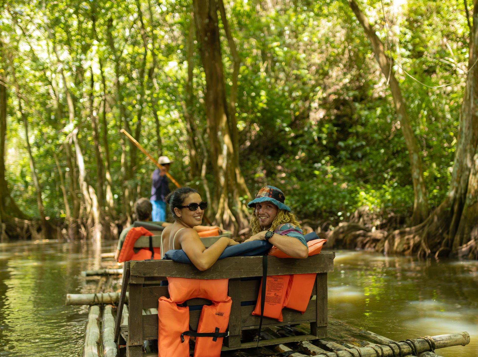A group of people are floating down a river on a raft.