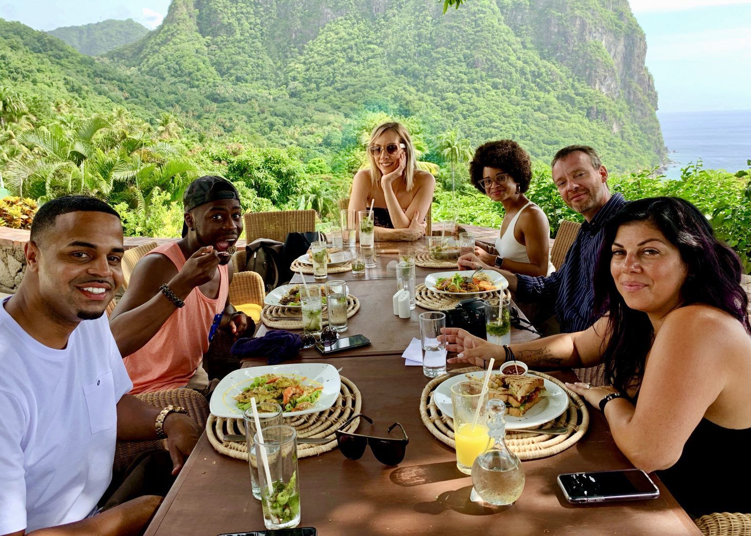 A group of people are sitting at a table with plates of food.