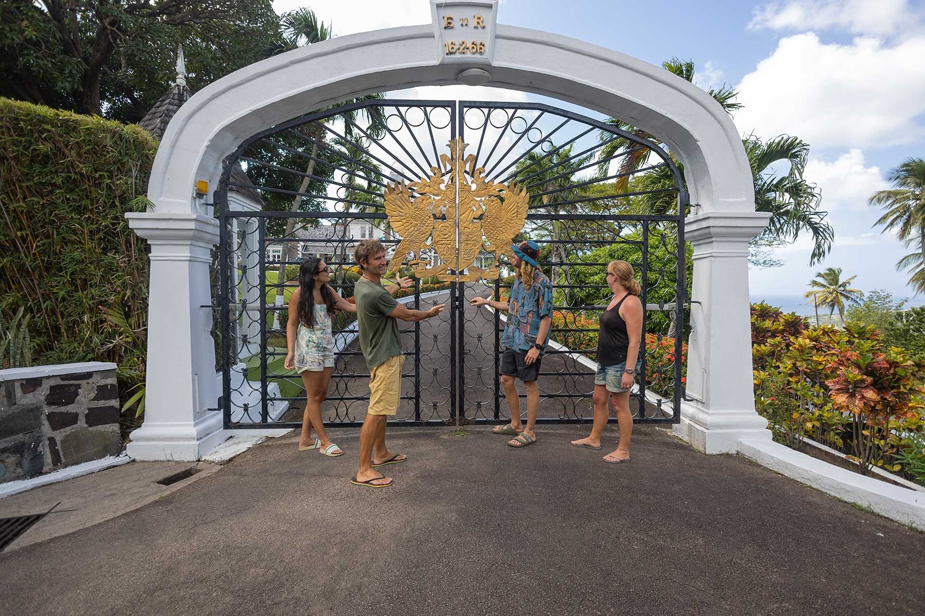 A group of people are standing in front of a gate.