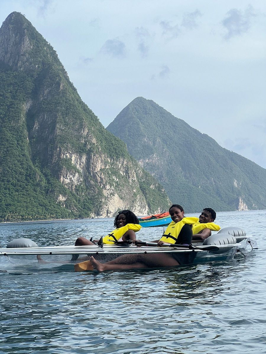 A group of people are floating on a boat in the water.