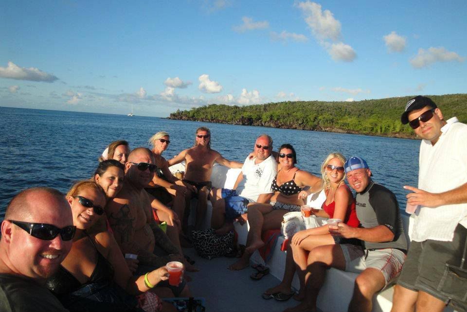 A group of people are sitting on a boat in the ocean