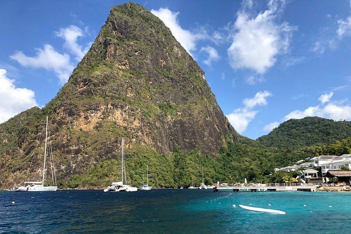 A large mountain is surrounded by a body of water.