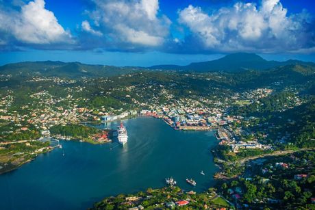 An aerial view of a large body of water surrounded by mountains and a city.