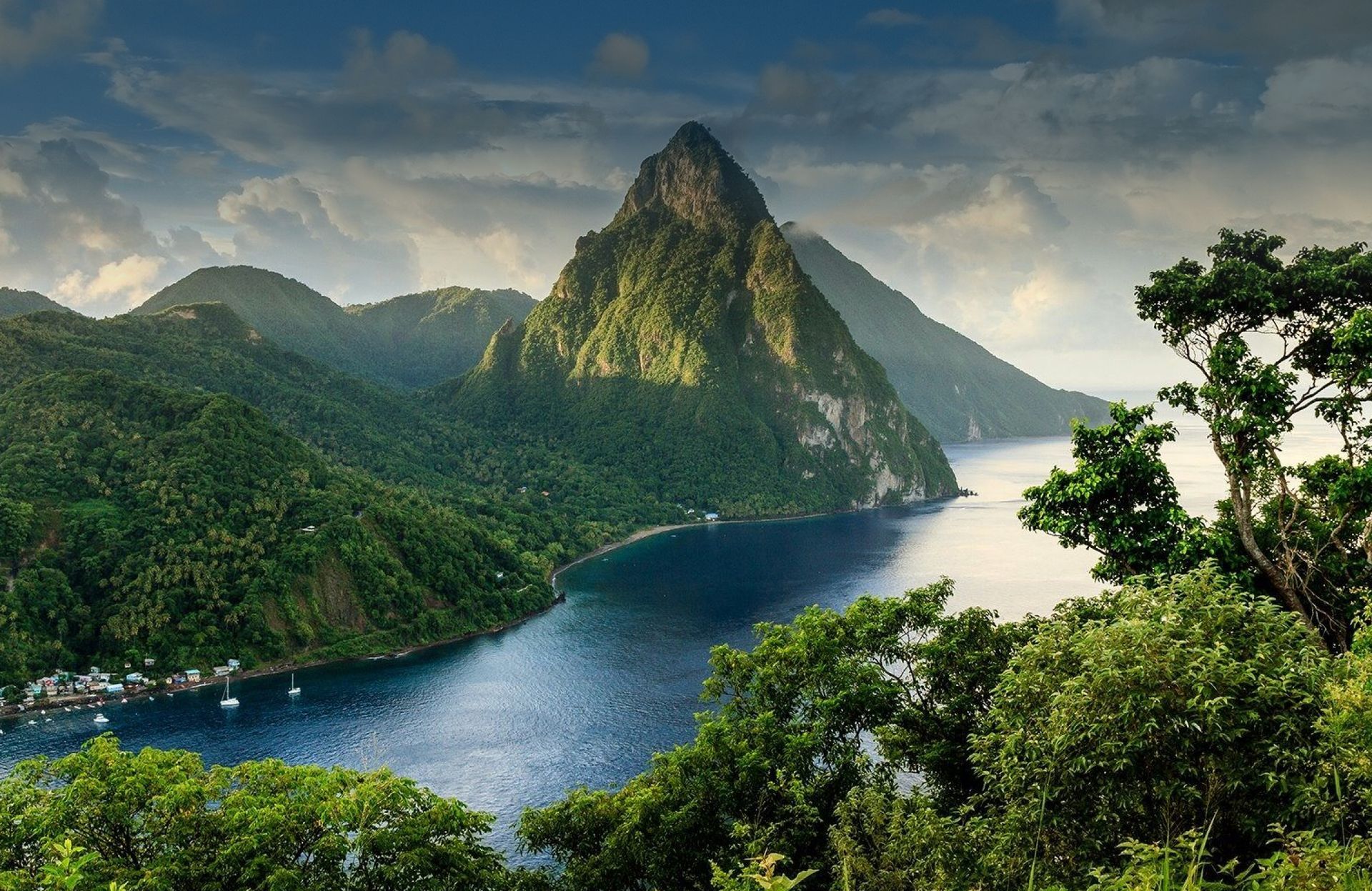 A lake surrounded by mountains and trees with a mountain in the background