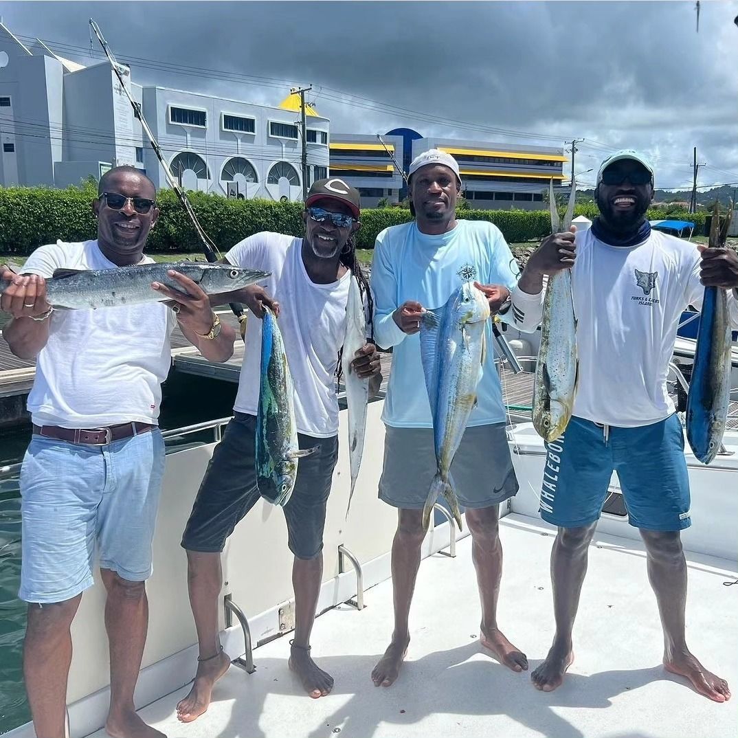 A group of men are standing on a boat holding fish.