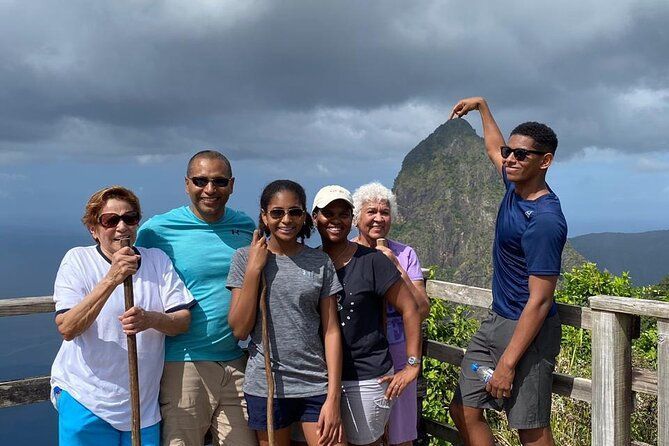 A group of people are posing for a picture on top of a mountain.